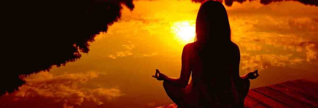 meditating at sunset