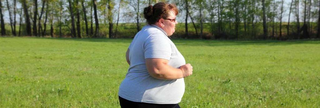 overweight woman running for fitness to manage diabetes