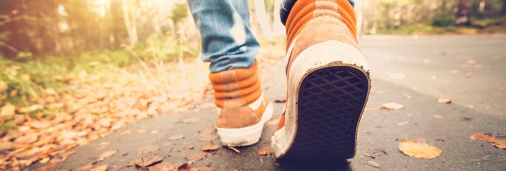 orange sneakers of someone walking away