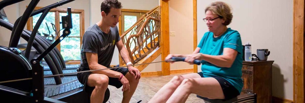 jeff ford working with client on rowing machine