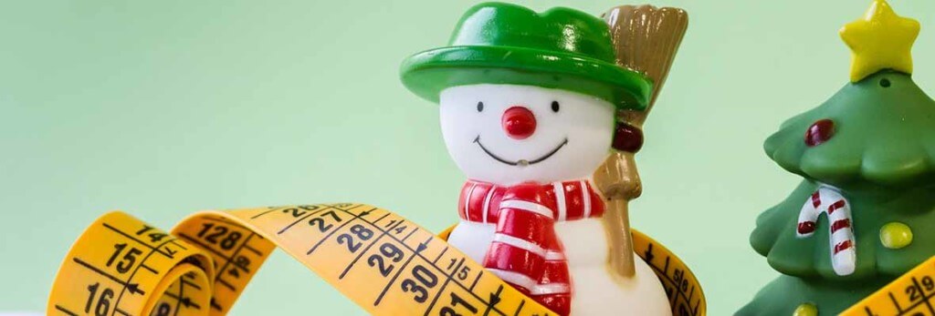 santa figurine and measuring tape