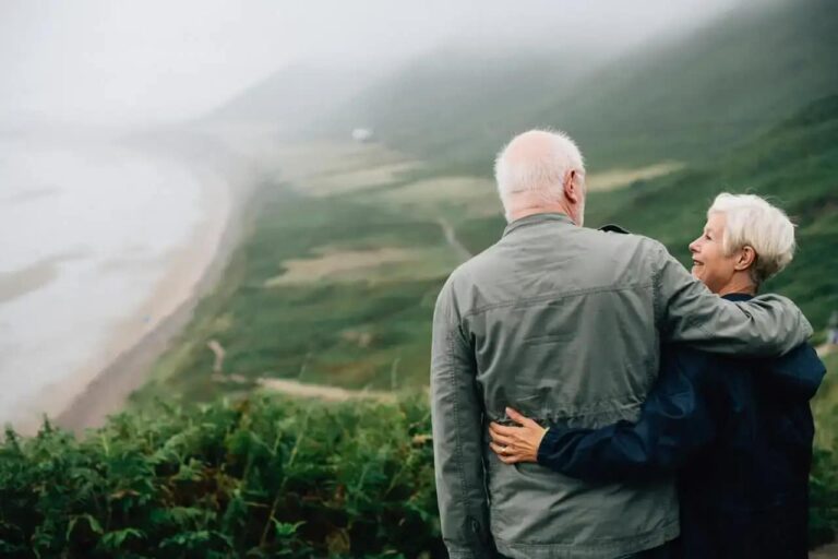 couple holding each other outside on a scenic overlook