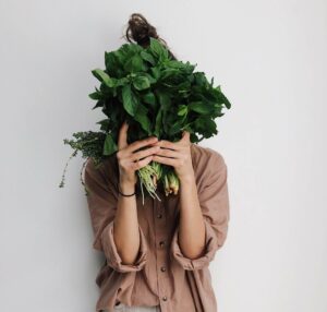 Person holding vegetables