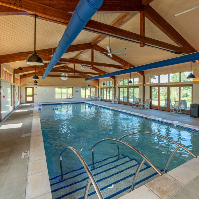 Skyterra indoor pool under a wood-beamed ceiling