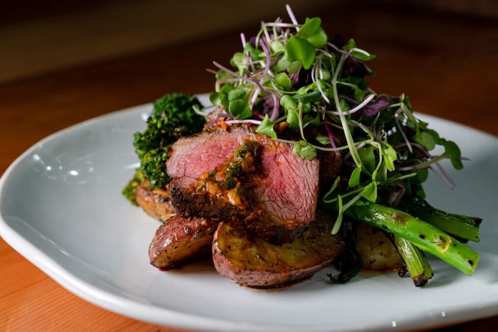 Seared steak with roasted potatoes, broccolini and microgreens