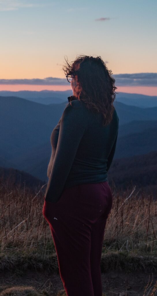 Guest looking out over Blue Ridge Mountain ridgelines at sunset